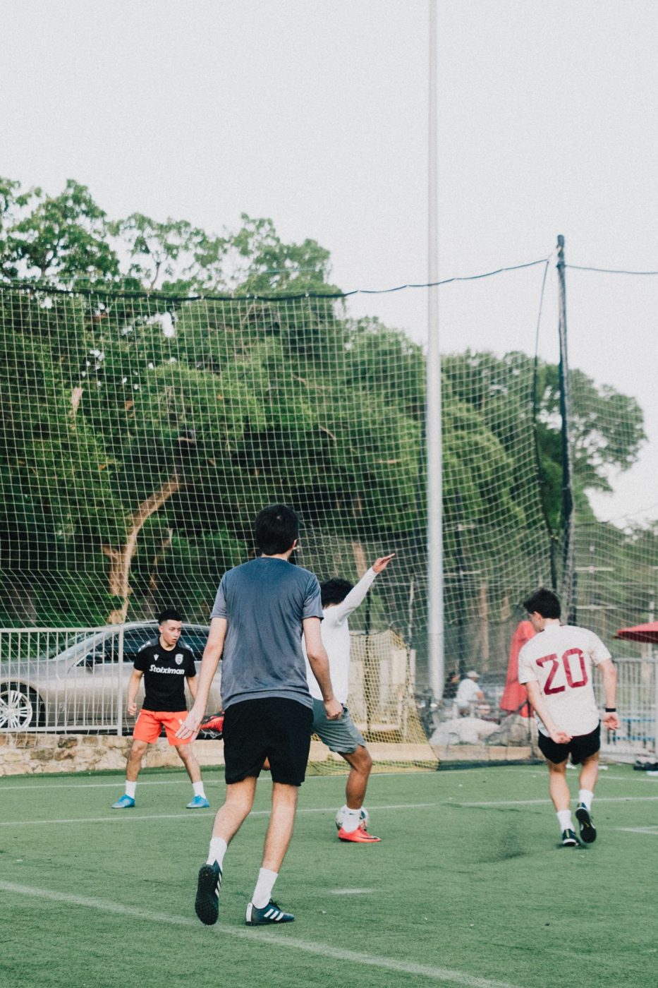 Adult players in a game on the turf field